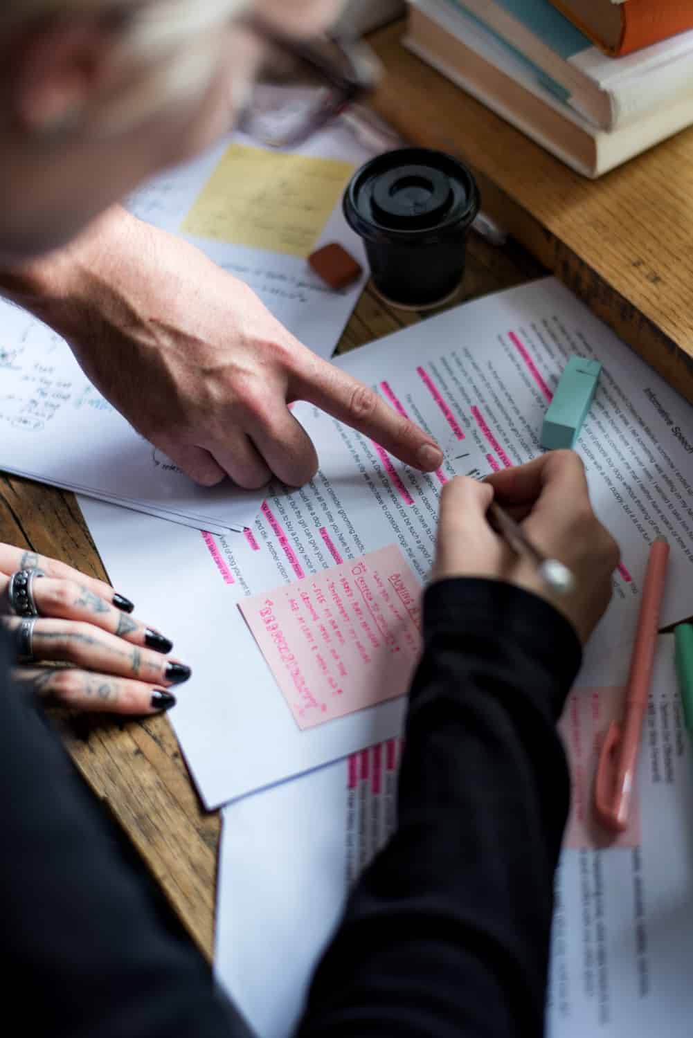 a person pointing at a piece of paper